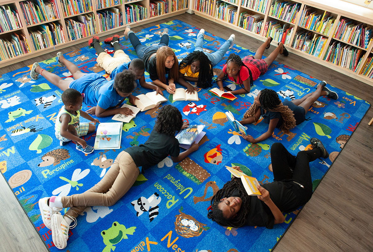 Reed—Children-in-Library-web Bezos Academy Preschool